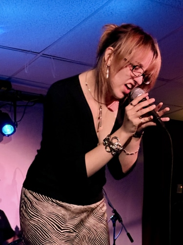 Sydney Bishop signing on stage